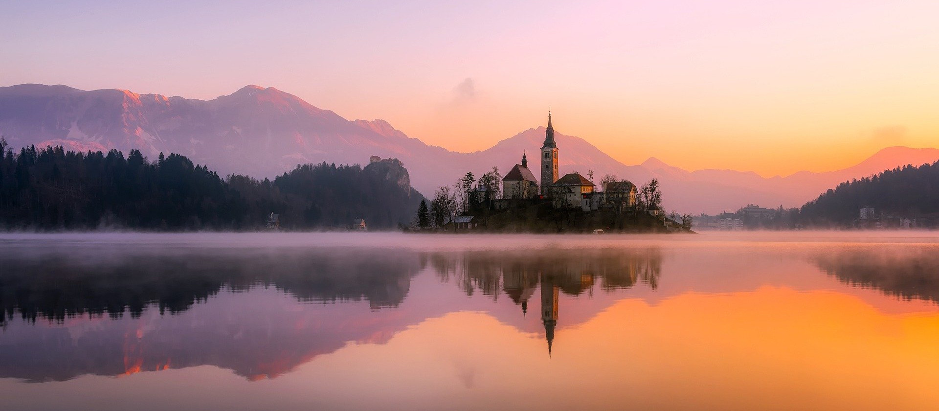 Buildings across a lake in Slovenia